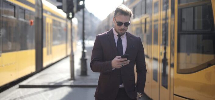 businessman using smartphone on street