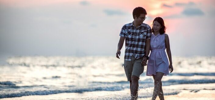 Couple Holding Hands By the Beach