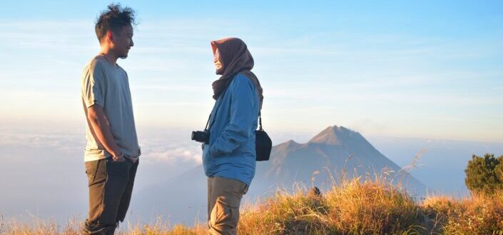 people standing on a hilltop