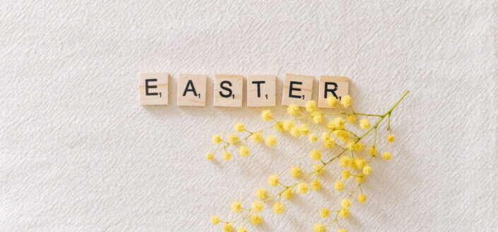 Easter text on tiles by flowers