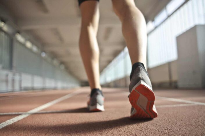 Fit runner standing on racetrack