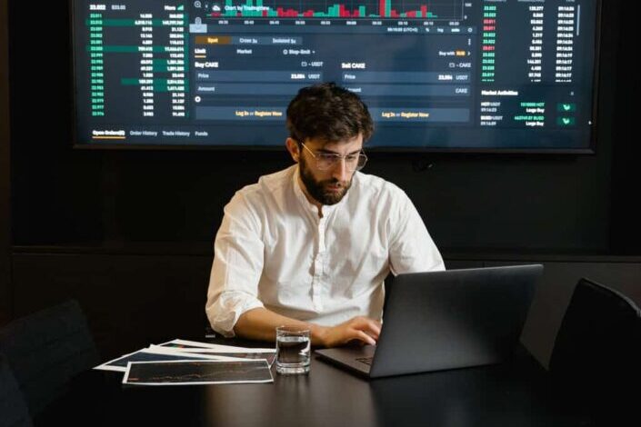 Focused professional man using laptop