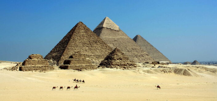 Gray pyramid on desert under blue sky