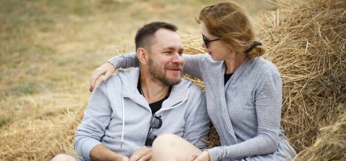 Man and Woman Sitting on Hay