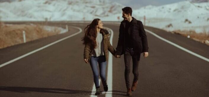 Man and Woman Walking on an Empty Road