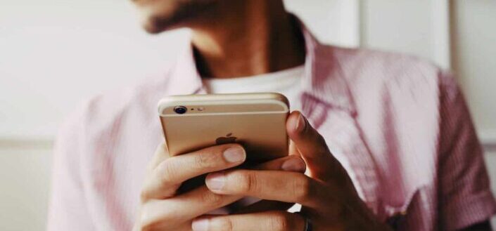 man holding gold iPhone 6