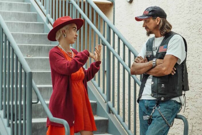 Tough Man talking to elegant woman