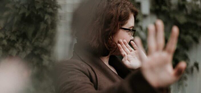 man in brown sweater wearing black framed eyeglasses