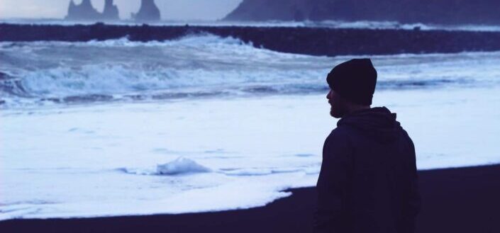 Man Looking at the Ocean By Himself