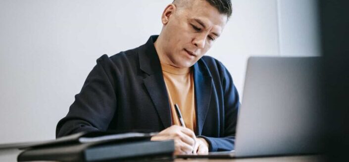 a man holding a pen while working