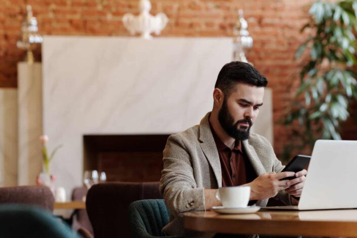 Man sitting on table with laptop