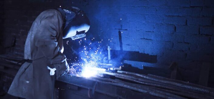 man wearing safety gear while welding