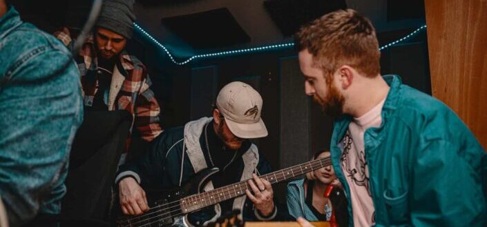 Men playing guitars at party