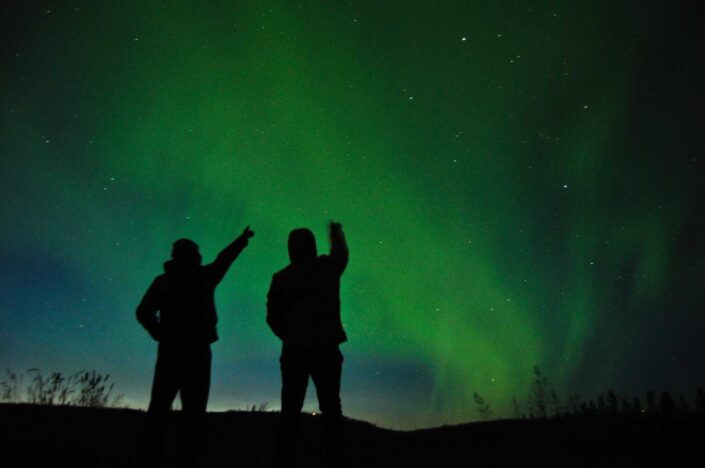 people watching the northern lights