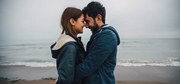 Couple nose kissing near sea