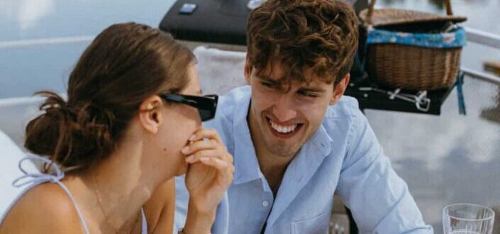 Couple Laughing Together While Having a Picnic