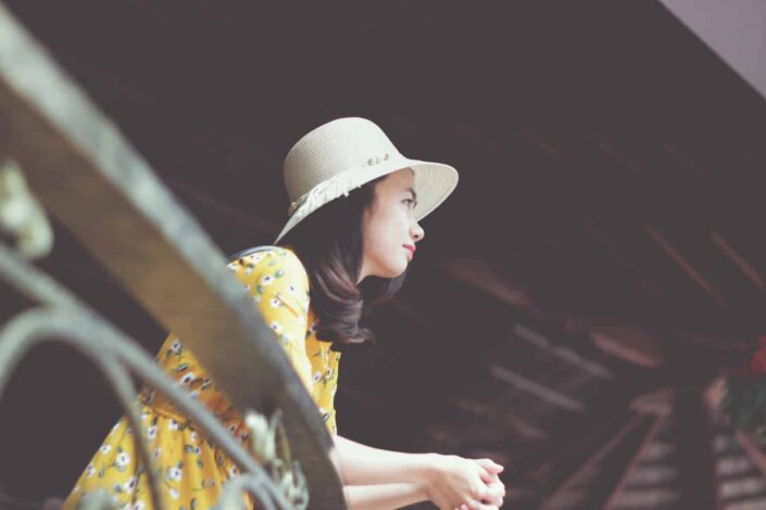 woman in sun hat and floral dress