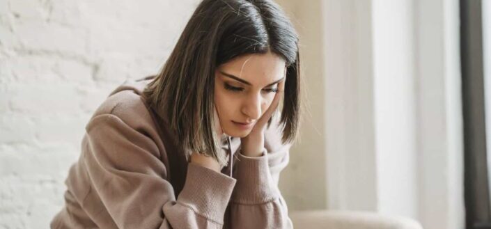 Sad woman sitting on couch