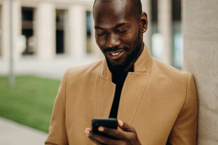 smiling man looking at his phone