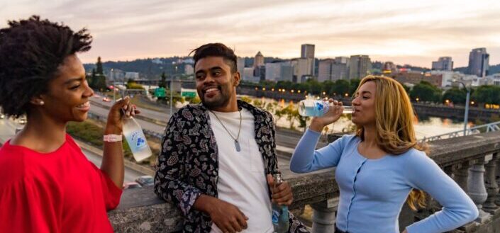 group of friends drinking on a bridge