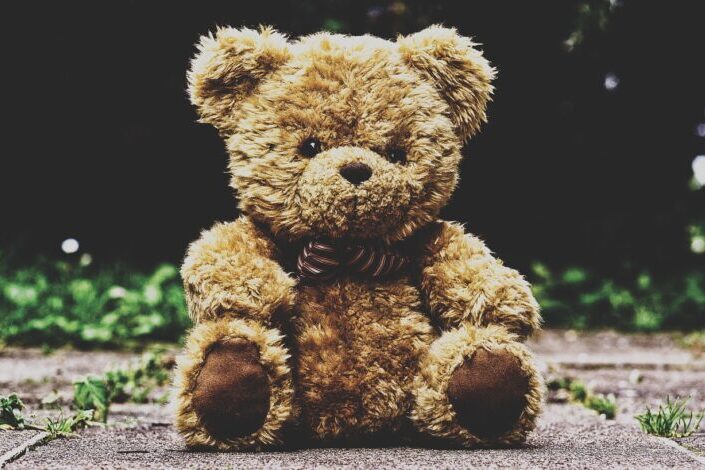 Stuffed Teddy Bear on a Sidewalk