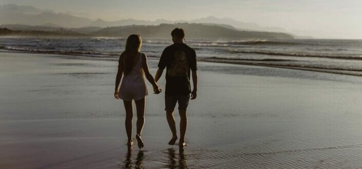 Couple Walking By the Sea Shore