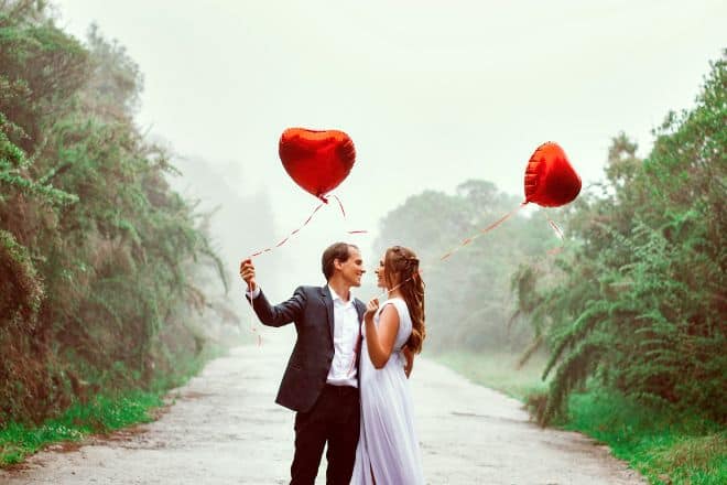 Couple Holding Heart Shaped Balloons - Valentine’s Day Captions