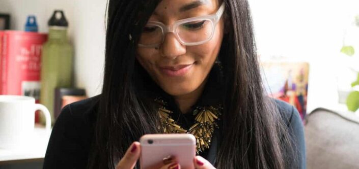 Woman holding her rose gold iphone 6