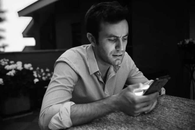 Young Man Texting During the Evening - Text To Make Any Woman Obsess Over You