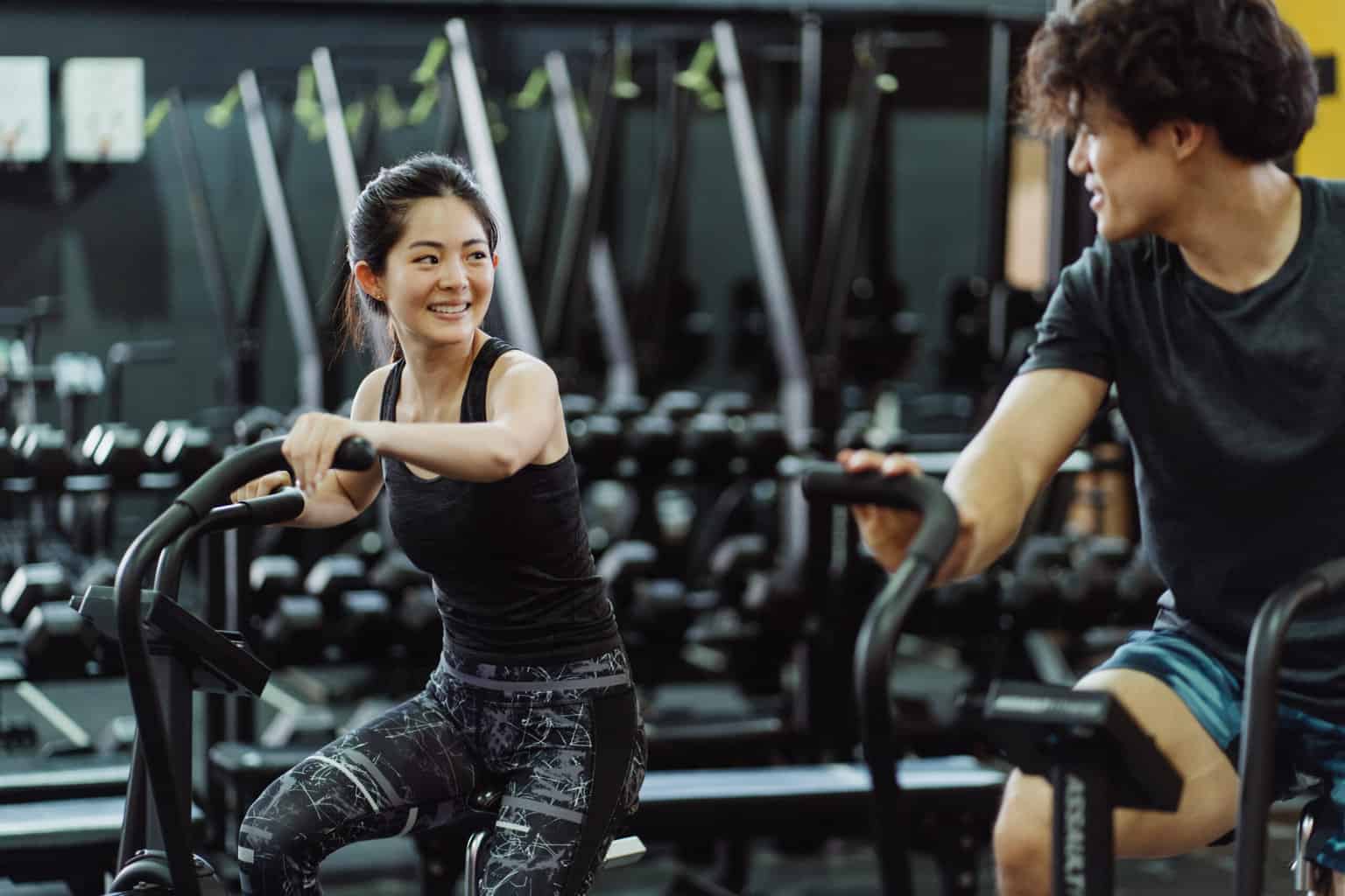 A couple using elliptical trainers