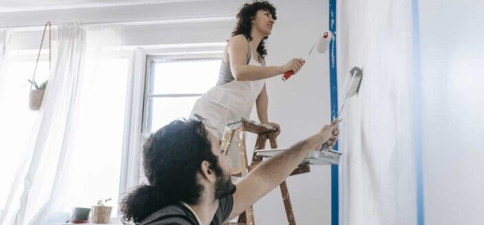 Couple painting a wall