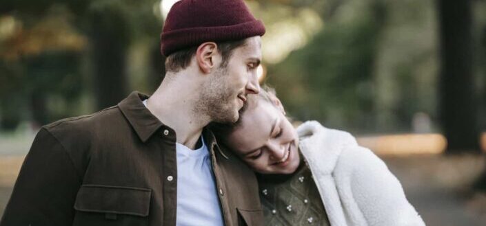 Loving young couple cuddling in autumn park