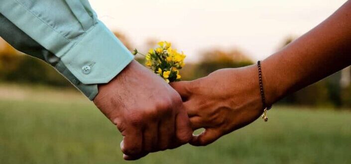 Two Person Holding Yellow Flower Bouquet