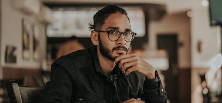 man in black jacket wearing eyeglasses